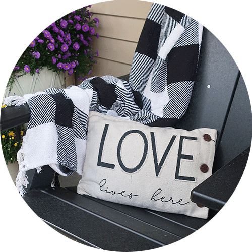 A black and white plaid blanket with a pillow on top.